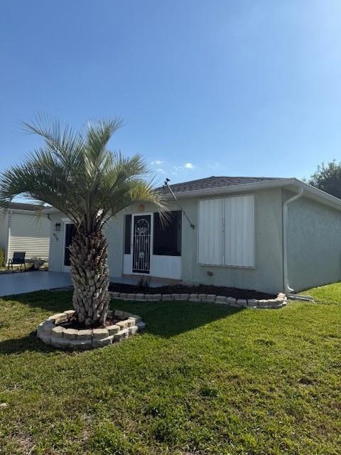 Undisclosed Address Fort Pierce, FL 34951 - Photo 2 of 10 a front view of a house with garden