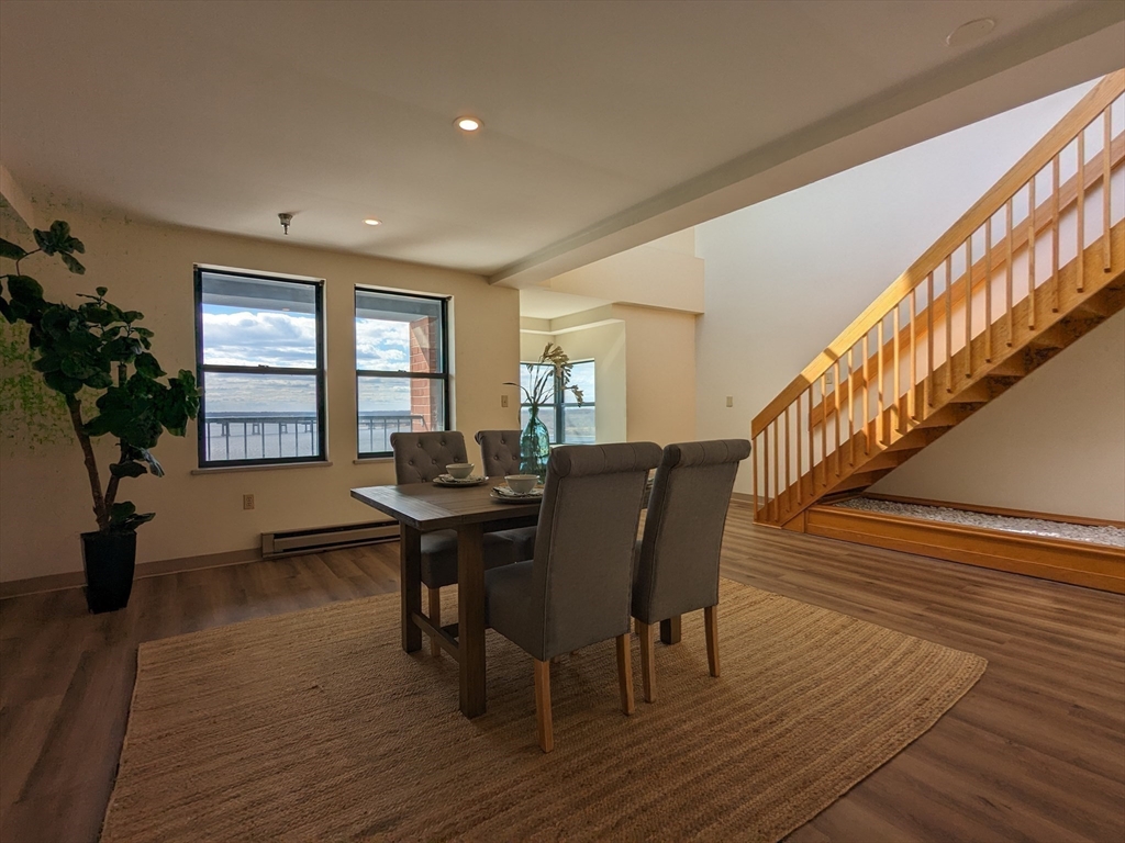 750 Davol Street, Unit 1214 Fall River, MA 02720 - Photo 11 of 42 a view of a dining room with furniture window and wooden floor