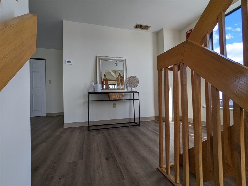 750 Davol Street, Unit 1214 Fall River, MA 02720 - Photo 14 of 42 a living room with wooden floor and a potted plant