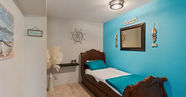a room with a bed and painting on the wall