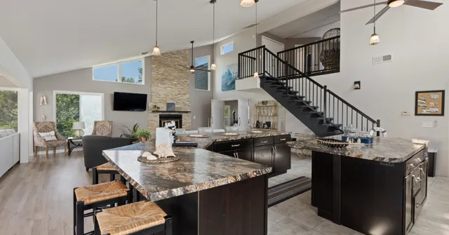 a dining room with wooden floor a chandelier a wooden table and chairs