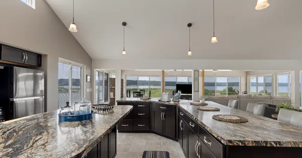 a kitchen with granite countertop a sink counter top space and stainless steel appliances