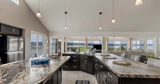 a kitchen with granite countertop a sink counter top space and stainless steel appliances