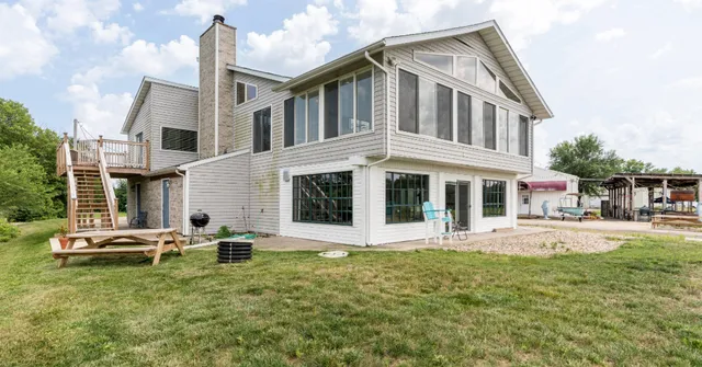 a front view of a house with a yard table and chairs