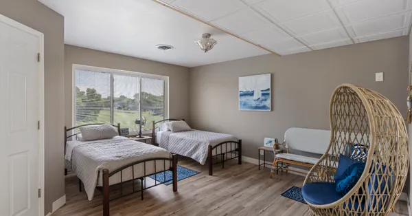 a bedroom with furniture and a window