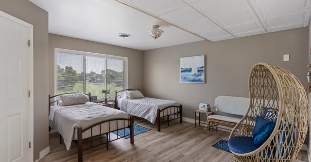 a bedroom with furniture and a window