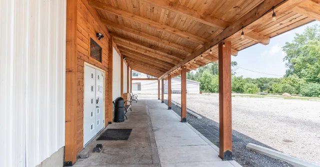 a view of a porch with furniture and floor to ceiling window