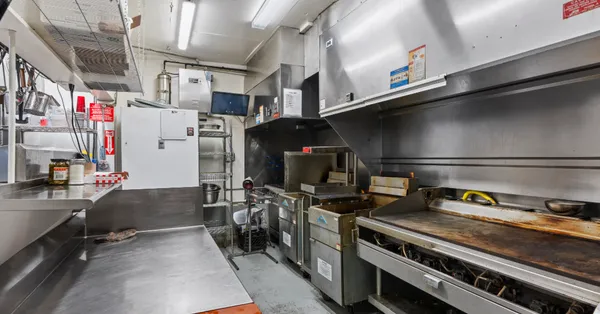 a kitchen with refrigerator and stove