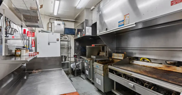 a kitchen with refrigerator and stove