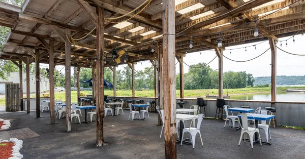 a view of chairs and table in patio with a lake view
