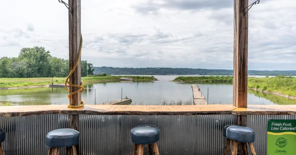 a view of sitting space next to a lake