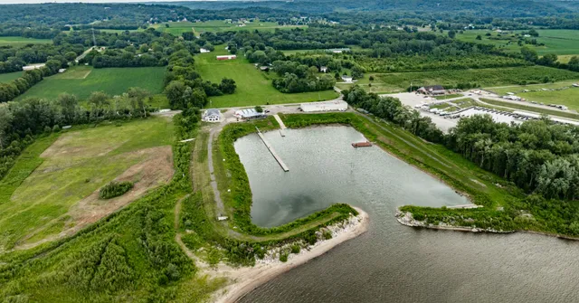 an aerial view of a residential houses with outdoor space and street view