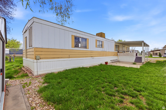2491 Highway 89, Unit 123 Pleasant View, UT 84404 - Photo 2 of 16 Back of property featuring a yard