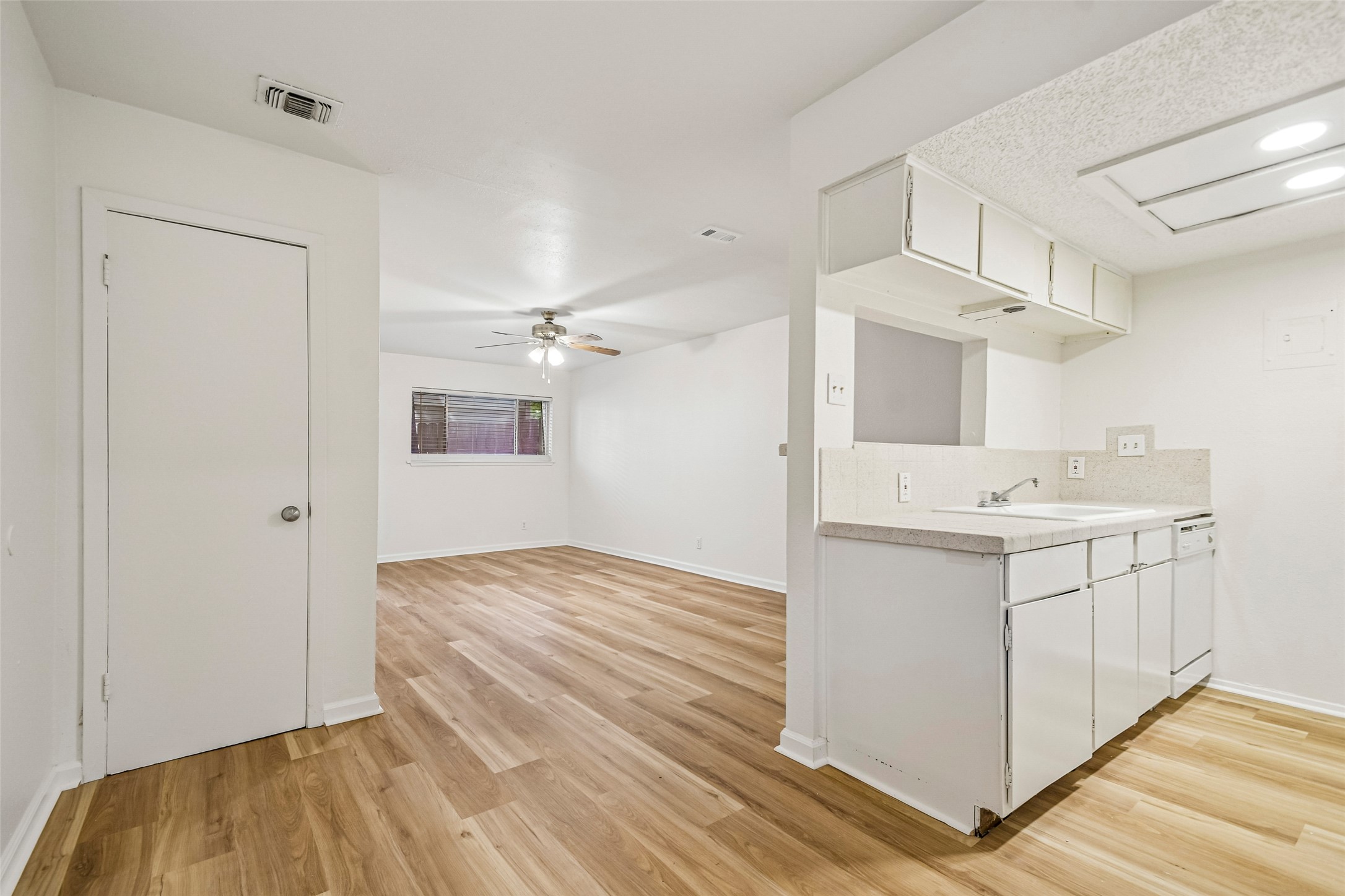 2413 Leon Street, Unit 104 Austin, TX 78705 - Photo 11 of 26 a view of hallway with sink and wooden floor