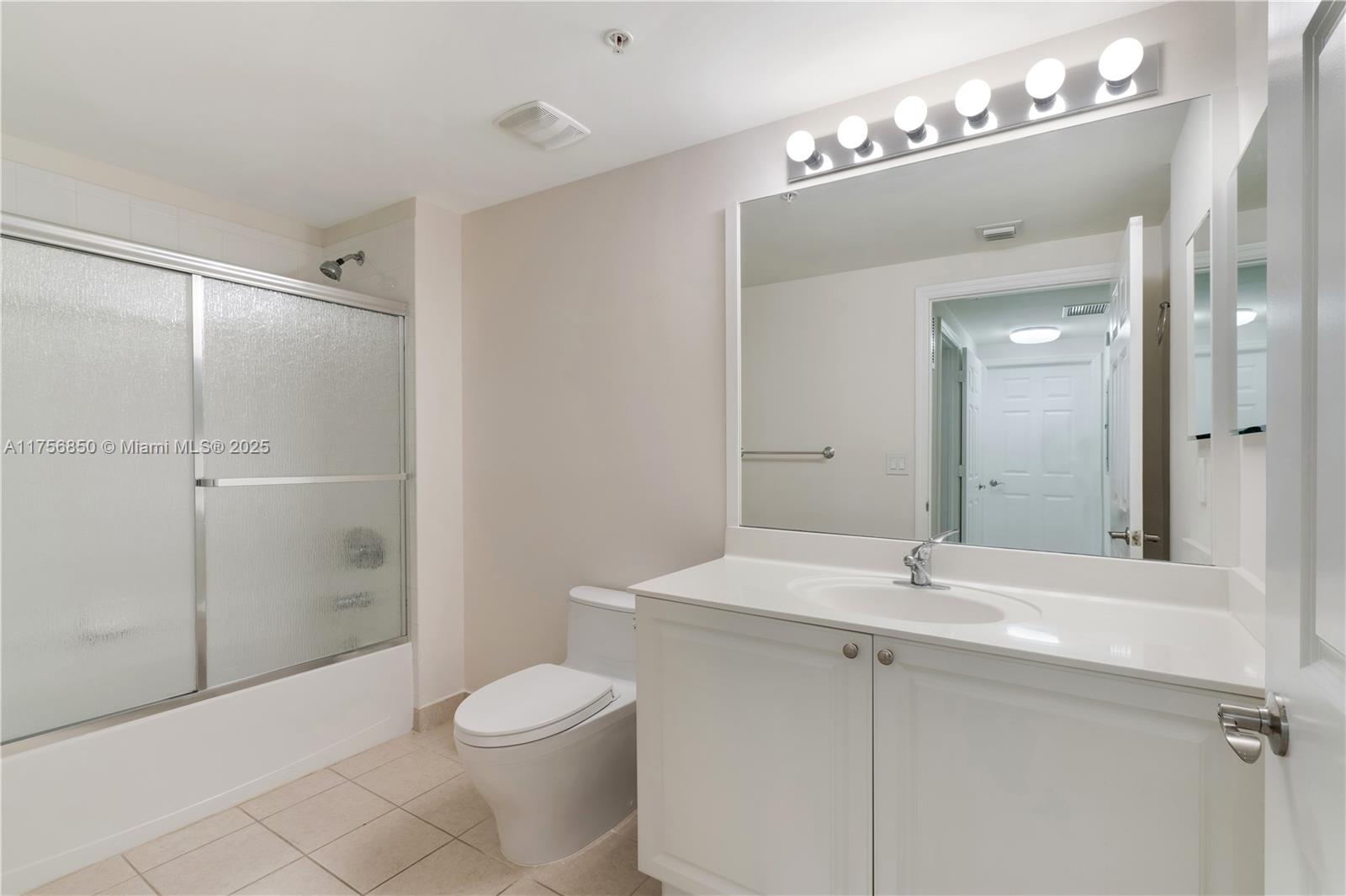 888 Douglas Road, Unit 404 Coral Gables, FL 33134 - Photo 14 of 21 a bathroom with a sink toilet a mirror and shower