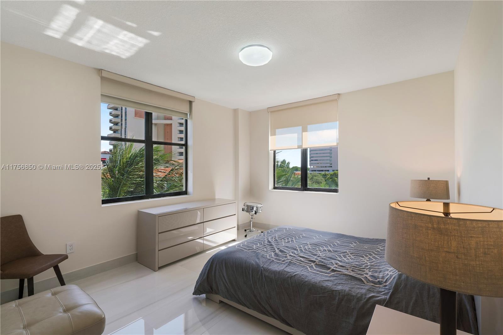 888 Douglas Road, Unit 404 Coral Gables, FL 33134 - Photo 9 of 21 a bedroom with a bed and a window