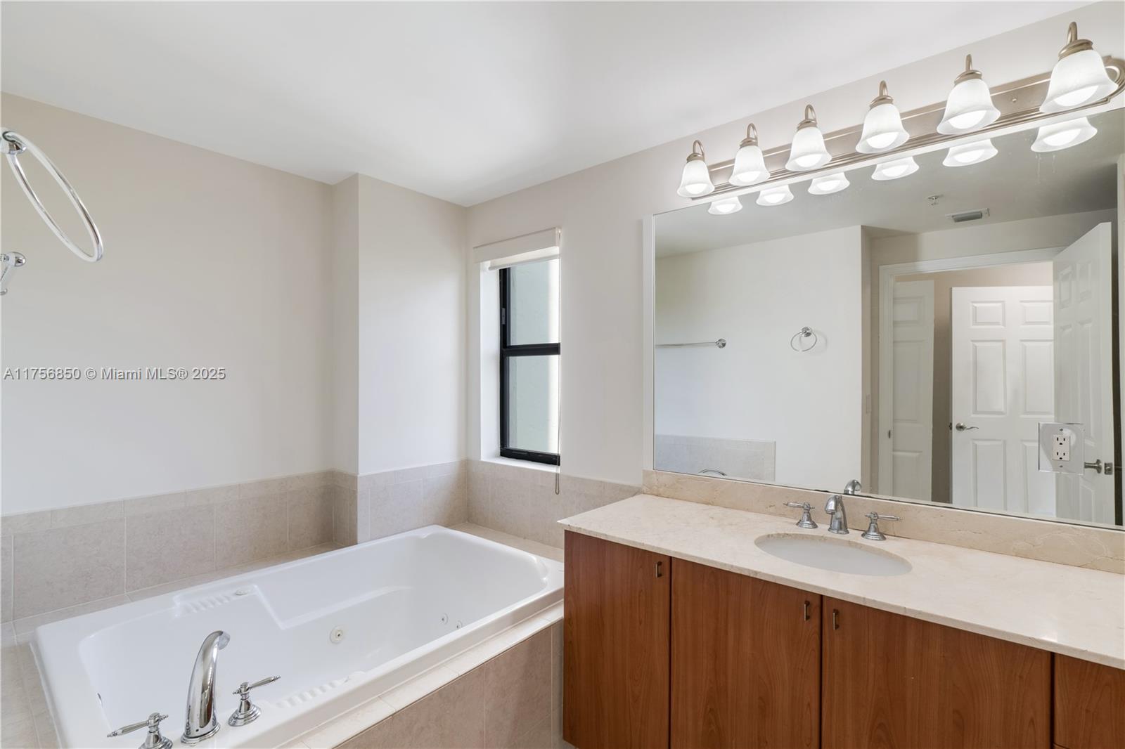 888 Douglas Road, Unit 404 Coral Gables, FL 33134 - Photo 10 of 21 a bathroom with a sink and a mirror