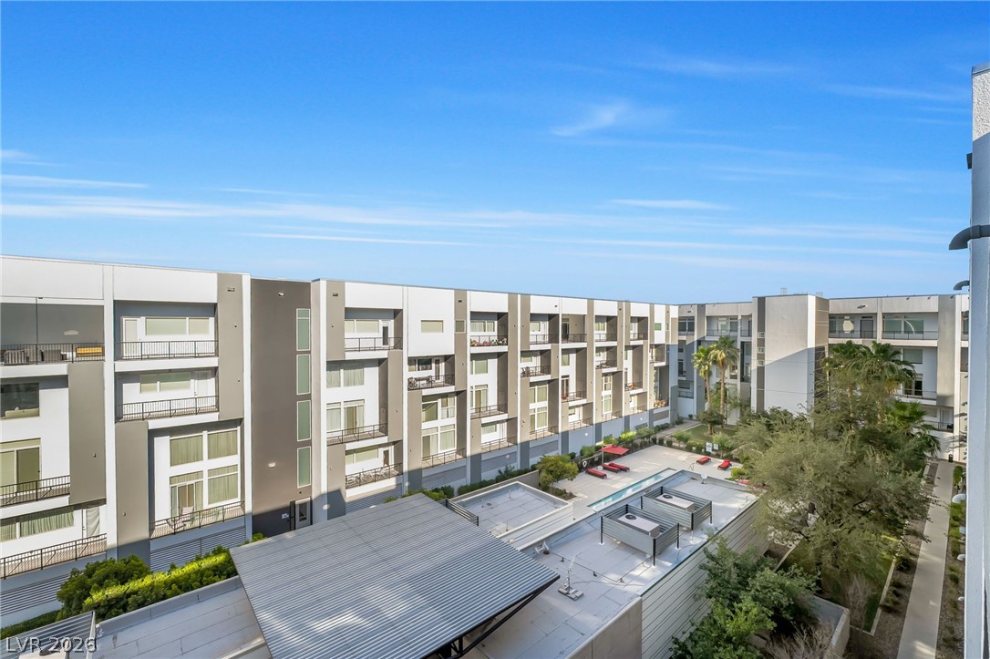 2775 West Pebble Road, Unit 505 Las Vegas, NV 89123 - Photo 19 of 26 An aerial perspective reveals a contemporary apartment complex with a central courtyard and swimming pool.