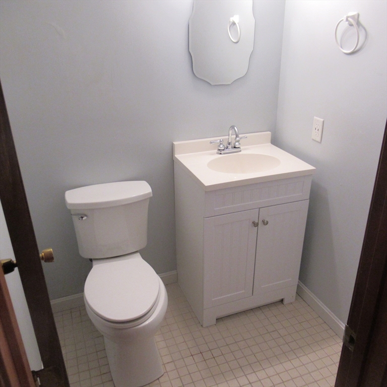 52 Apache Way, Unit 52 Tewksbury, MA 01876 - Photo 11 of 19 a white toilet sitting next to a bathroom sink