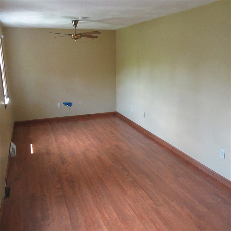52 Apache Way, Unit 52 Tewksbury, MA 01876 - Photo 12 of 19 a view of an empty room with wooden floor