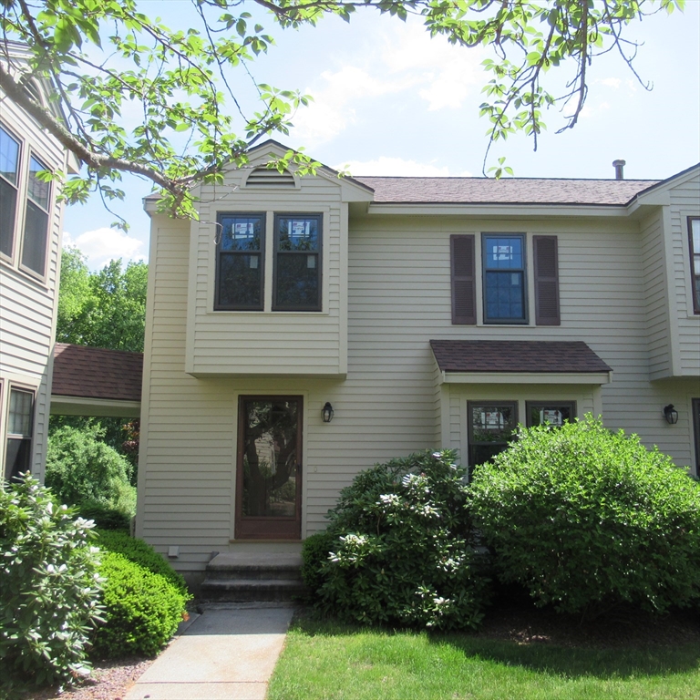 52 Apache Way, Unit 52 Tewksbury, MA 01876 - Photo 2 of 19 a front view of a house with garden