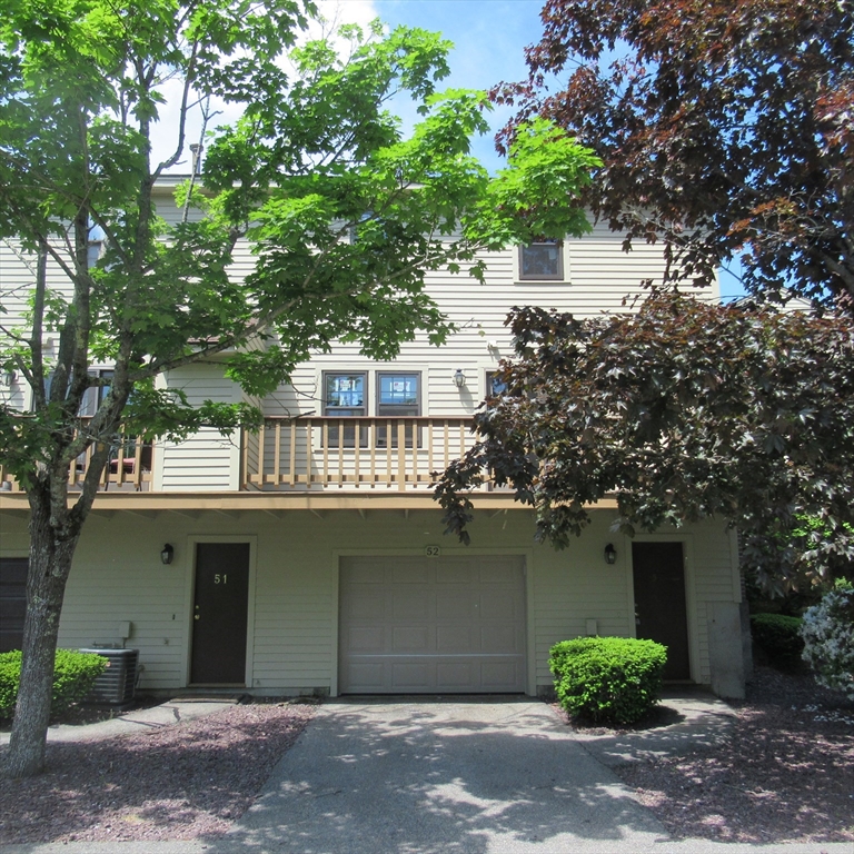52 Apache Way, Unit 52 Tewksbury, MA 01876 - Photo 3 of 19 a house with a tree in front of it