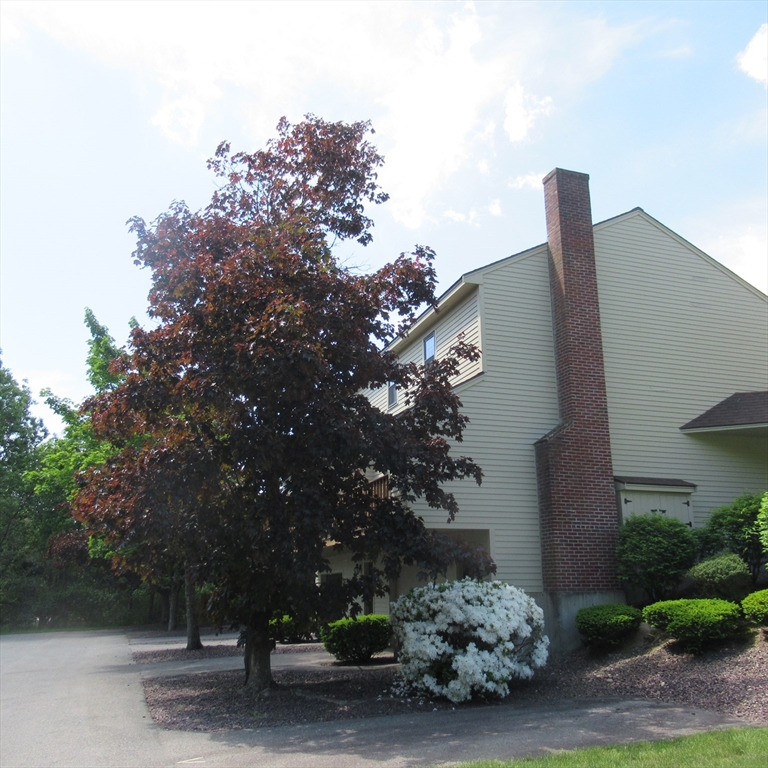 52 Apache Way, Unit 52 Tewksbury, MA 01876 - Photo 4 of 19 a view of a street with a house in the background
