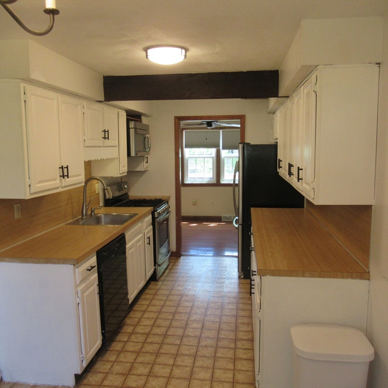 52 Apache Way, Unit 52 Tewksbury, MA 01876 - Photo 5 of 19 a kitchen with stainless steel appliances a sink stove and cabinets