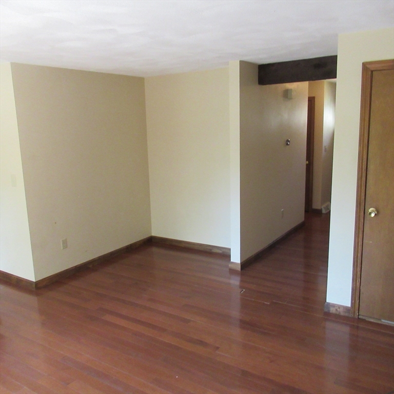 52 Apache Way, Unit 52 Tewksbury, MA 01876 - Photo 9 of 19 a view of an empty room with wooden floor and closet