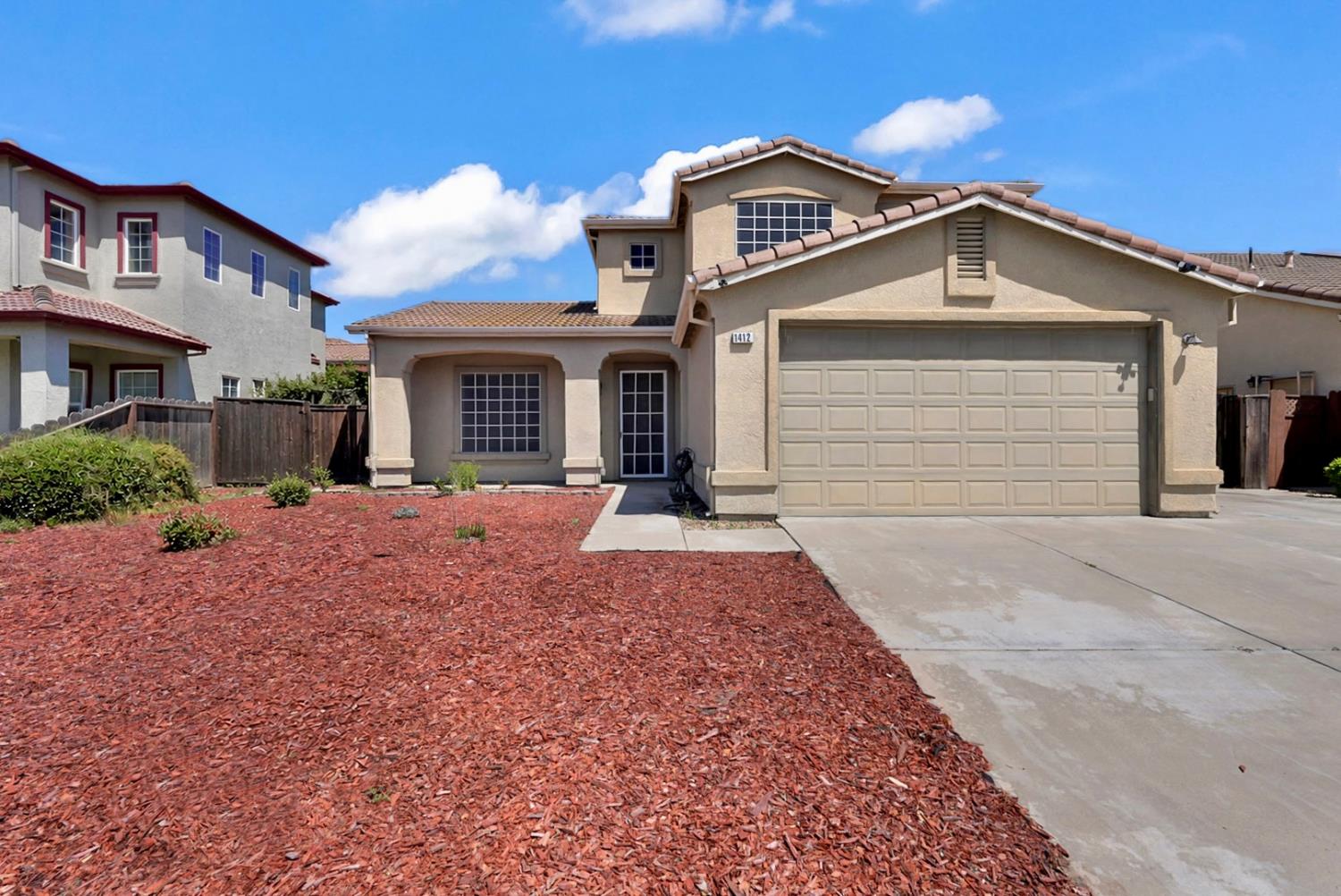 1412 Red Ribbons Lane Manteca, CA 95337 - Photo 3 of 32 a front view of a house with a yard