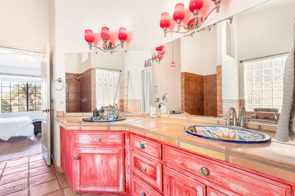 a kitchen with stainless steel appliances granite countertop a sink a stove a refrigerator and cabinets