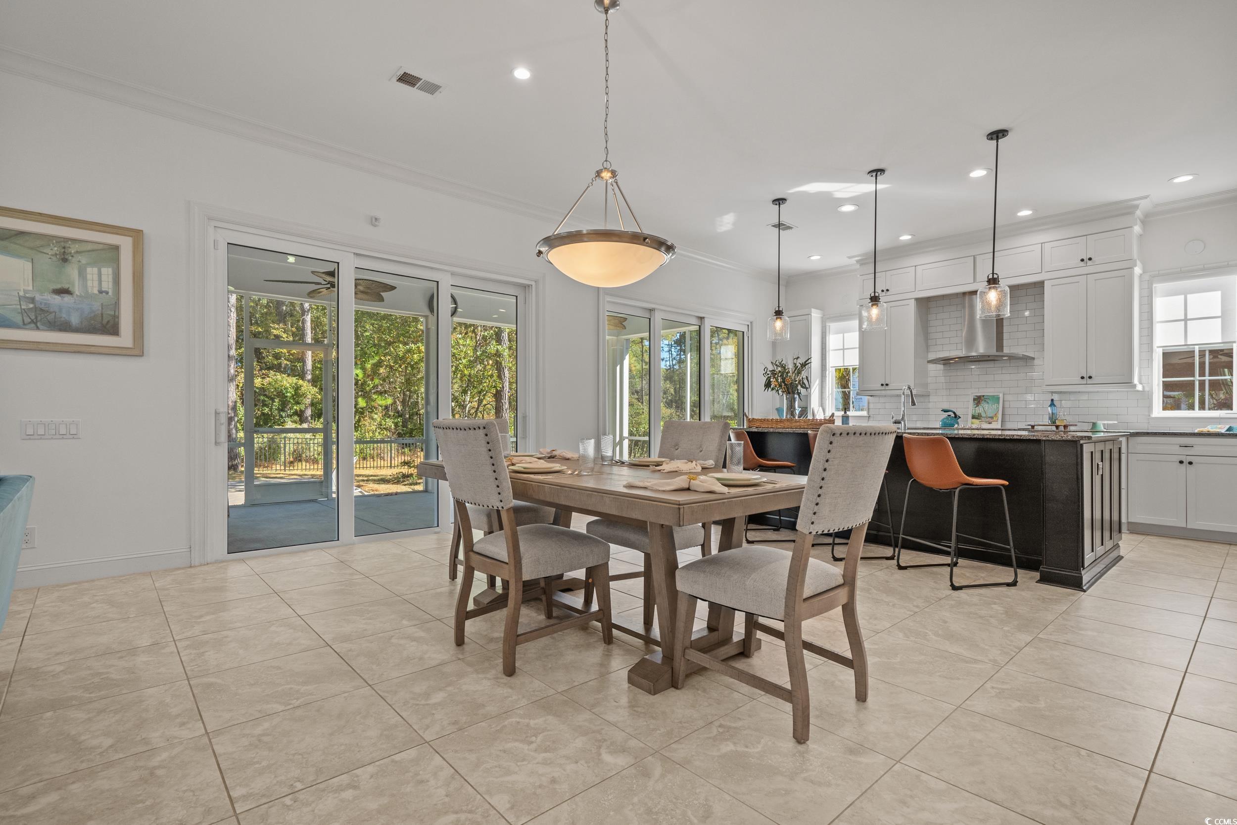 496 Starlit Way Myrtle Beach, SC 29579 - Photo 13 of 40 Dining space featuring ornamental molding, recessed lighting, and light tile patterned flooring