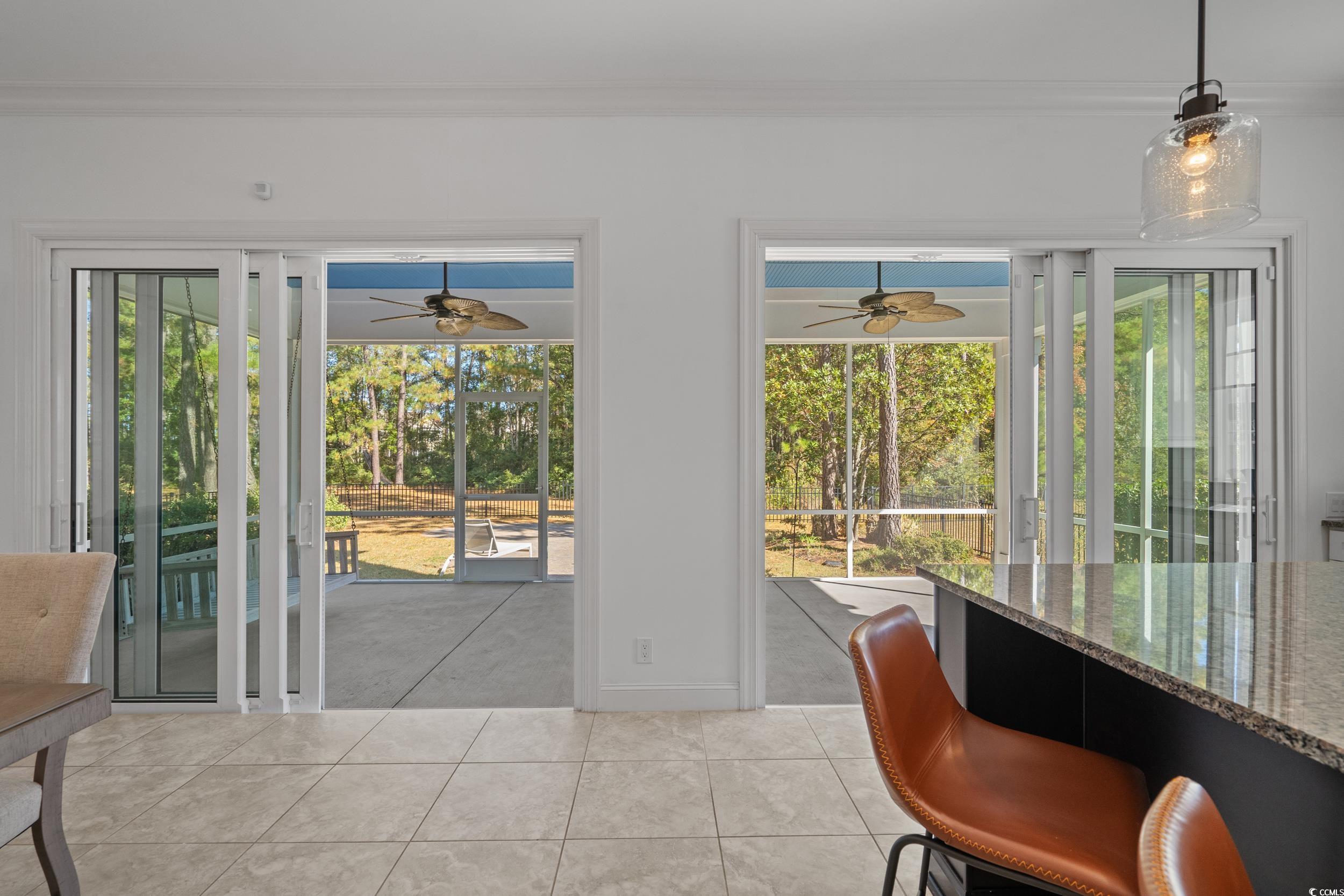 496 Starlit Way Myrtle Beach, SC 29579 - Photo 17 of 40 Doorway to outside with tile patterned floors and crown molding