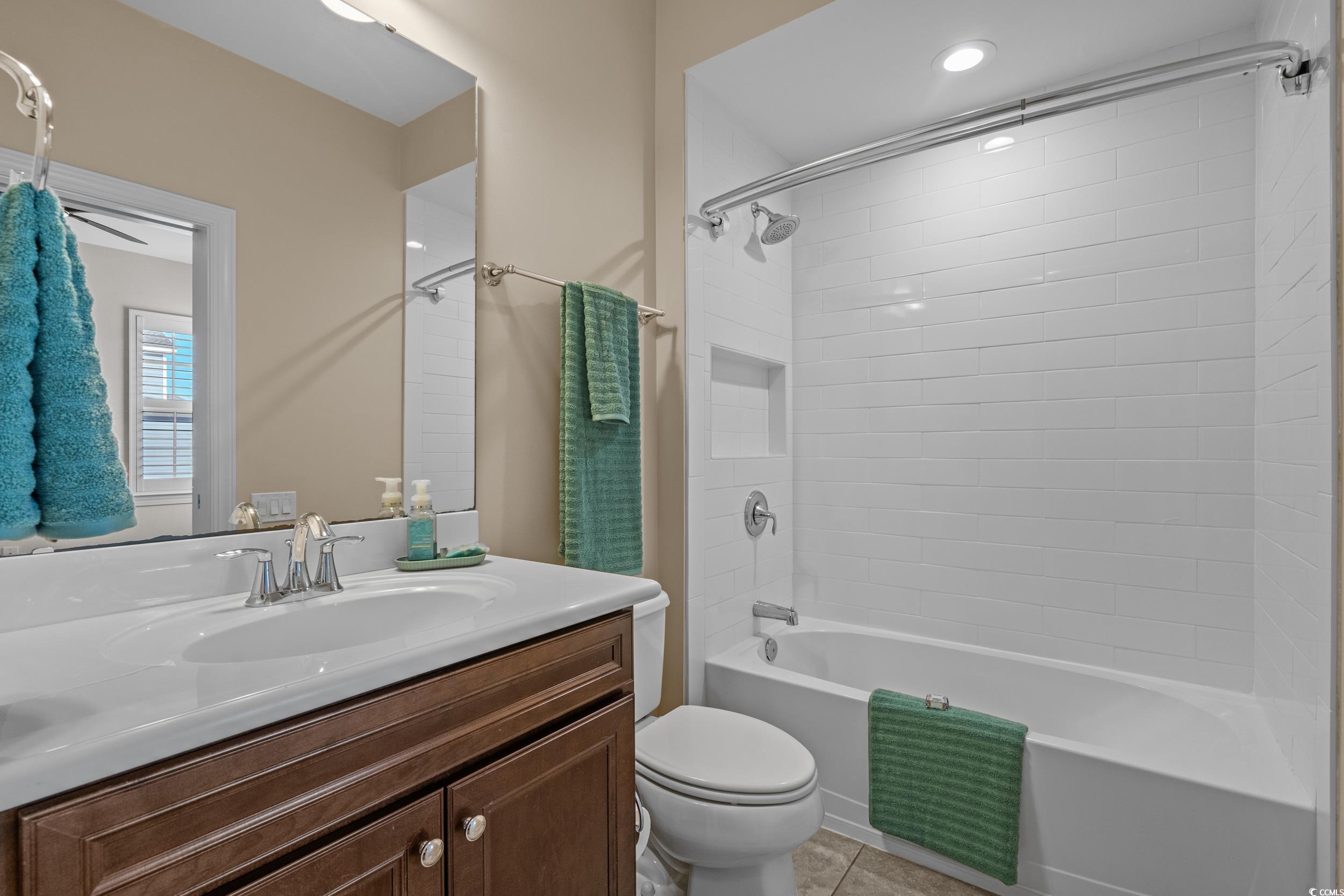 496 Starlit Way Myrtle Beach, SC 29579 - Photo 33 of 40 Bathroom featuring washtub / shower combination, vanity, and light tile patterned floors