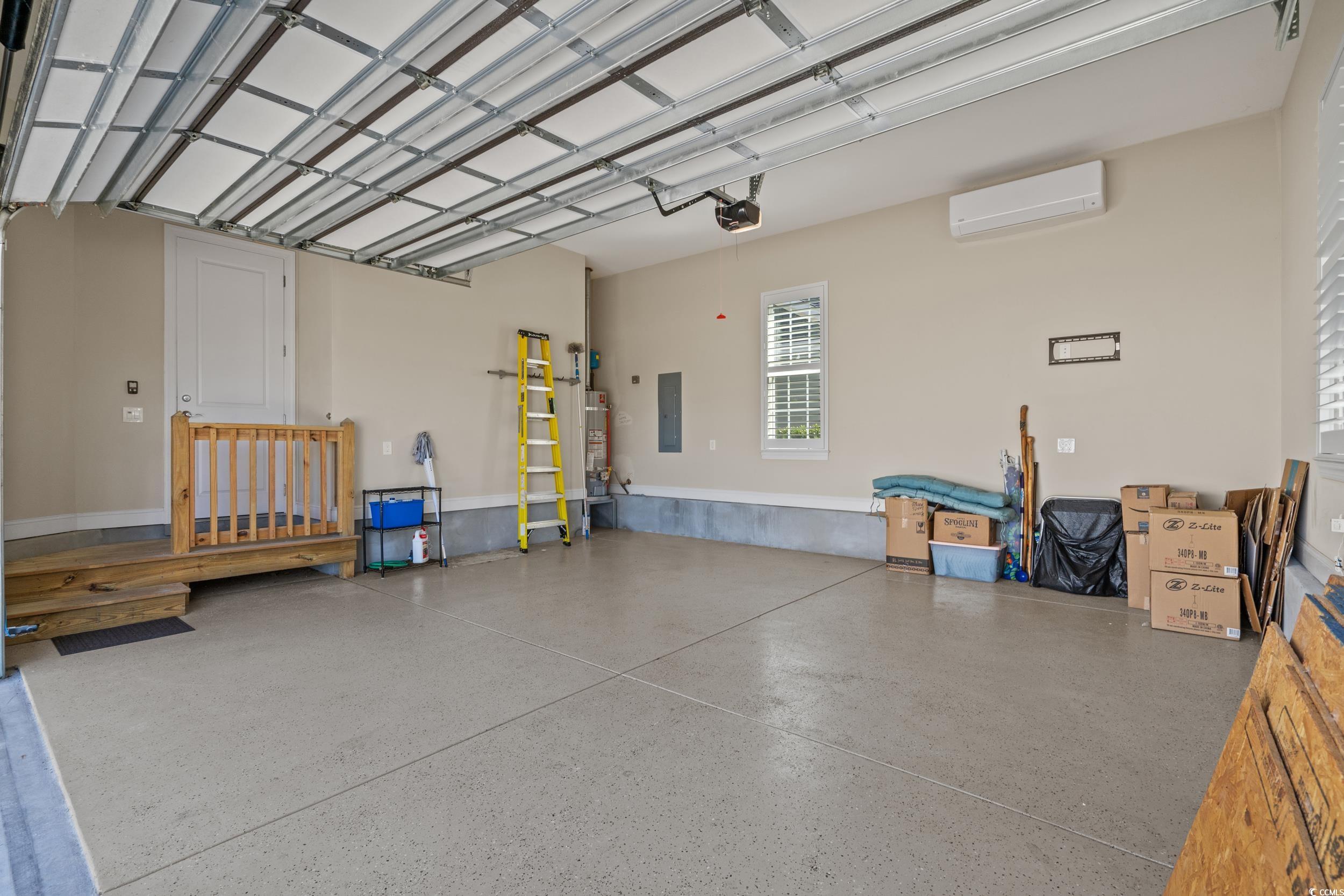 496 Starlit Way Myrtle Beach, SC 29579 - Photo 36 of 40 Garage with electric panel, water heater, and a wall mounted air conditioner