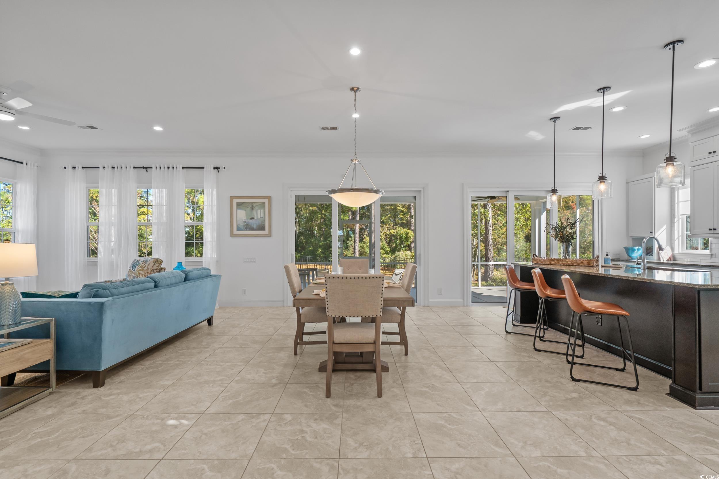 496 Starlit Way Myrtle Beach, SC 29579 - Photo 6 of 40 Dining area with recessed lighting, light tile patterned floors, and ornamental molding