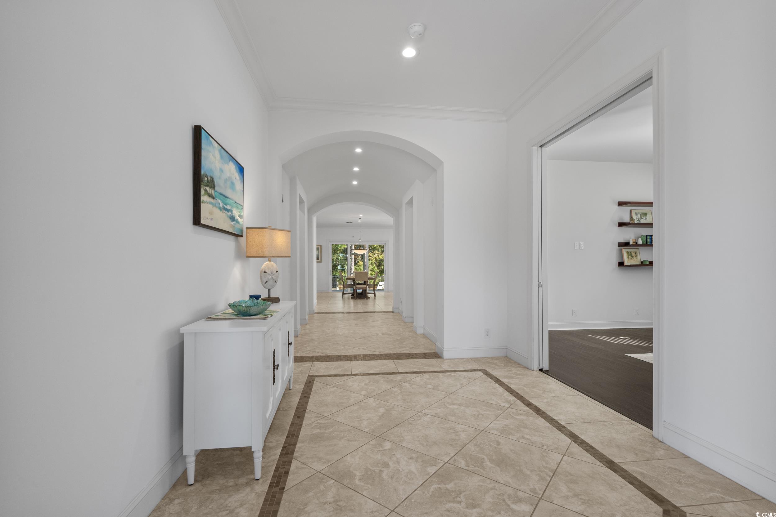 496 Starlit Way Myrtle Beach, SC 29579 - Photo 10 of 40 Corridor with recessed lighting, arched walkways, crown molding, and inlaid floor details