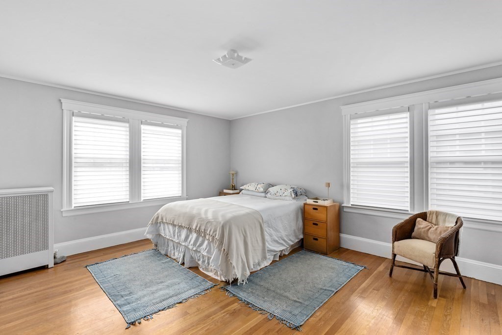 72 Salisbury Road Brookline, MA 02445 - Photo 21 of 40 a bedroom with a bed and a chair