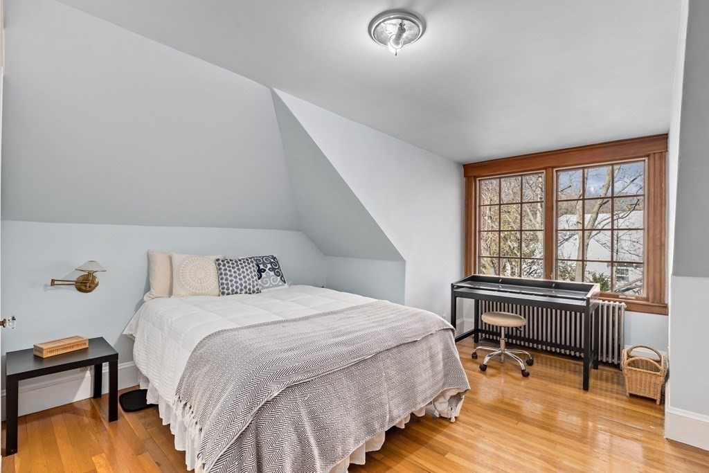 72 Salisbury Road Brookline, MA 02445 - Photo 28 of 40 a bedroom with a bed a table and a dresser next to a window