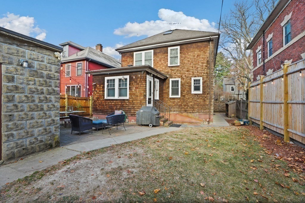 72 Salisbury Road Brookline, MA 02445 - Photo 34 of 40 a backyard of a house with sofas table and chairs
