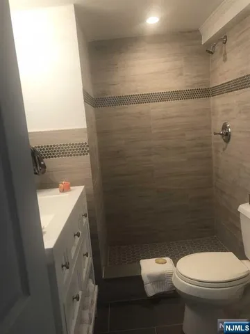 a bathroom with a toilet a sink and shower
