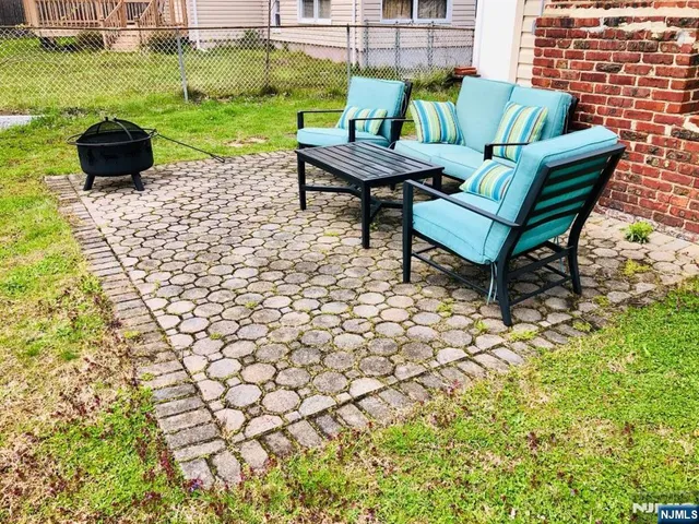 a backyard of a house with table and chairs