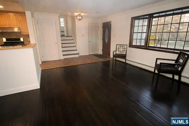a view of a room with wooden floor and a window