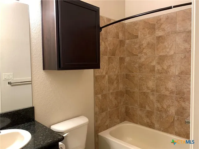 a bathroom with a toilet and a shower curtain
