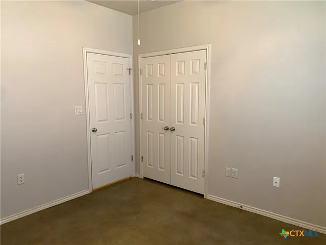 an empty room with closet area