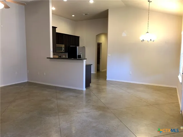 a view of a kitchen with a sink and a refrigerator