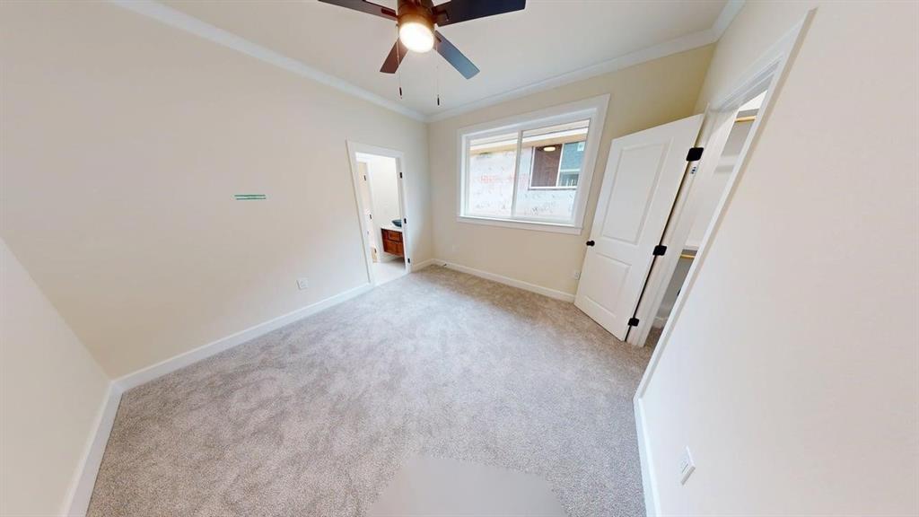 2509 Windmill Lane Longview, TX 75601 - Photo 14 of 35 bedroom featuring carpet floors, crown molding, and a ceiling fan