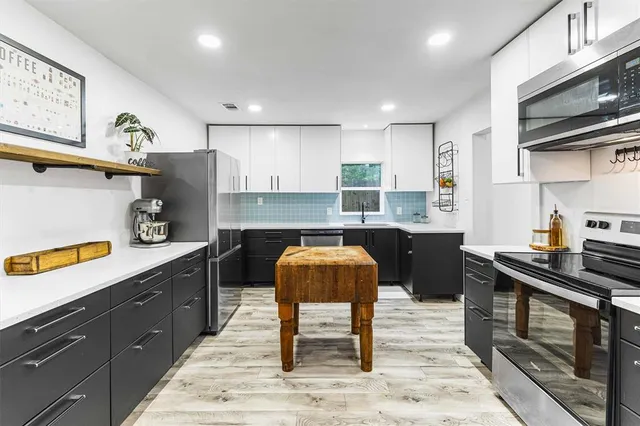 a kitchen with a sink cabinets and window