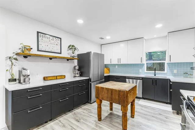 a kitchen with a refrigerator and a sink