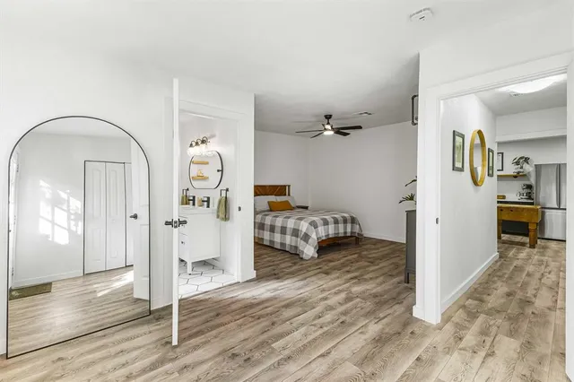 a view of a livingroom with wooden floor and white cabinet
